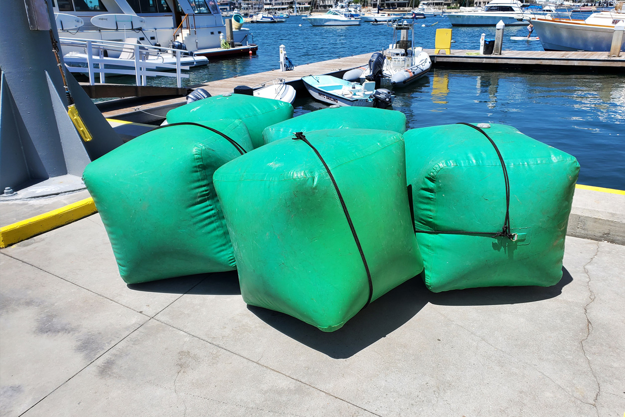 A bunch of green bags are on the ground